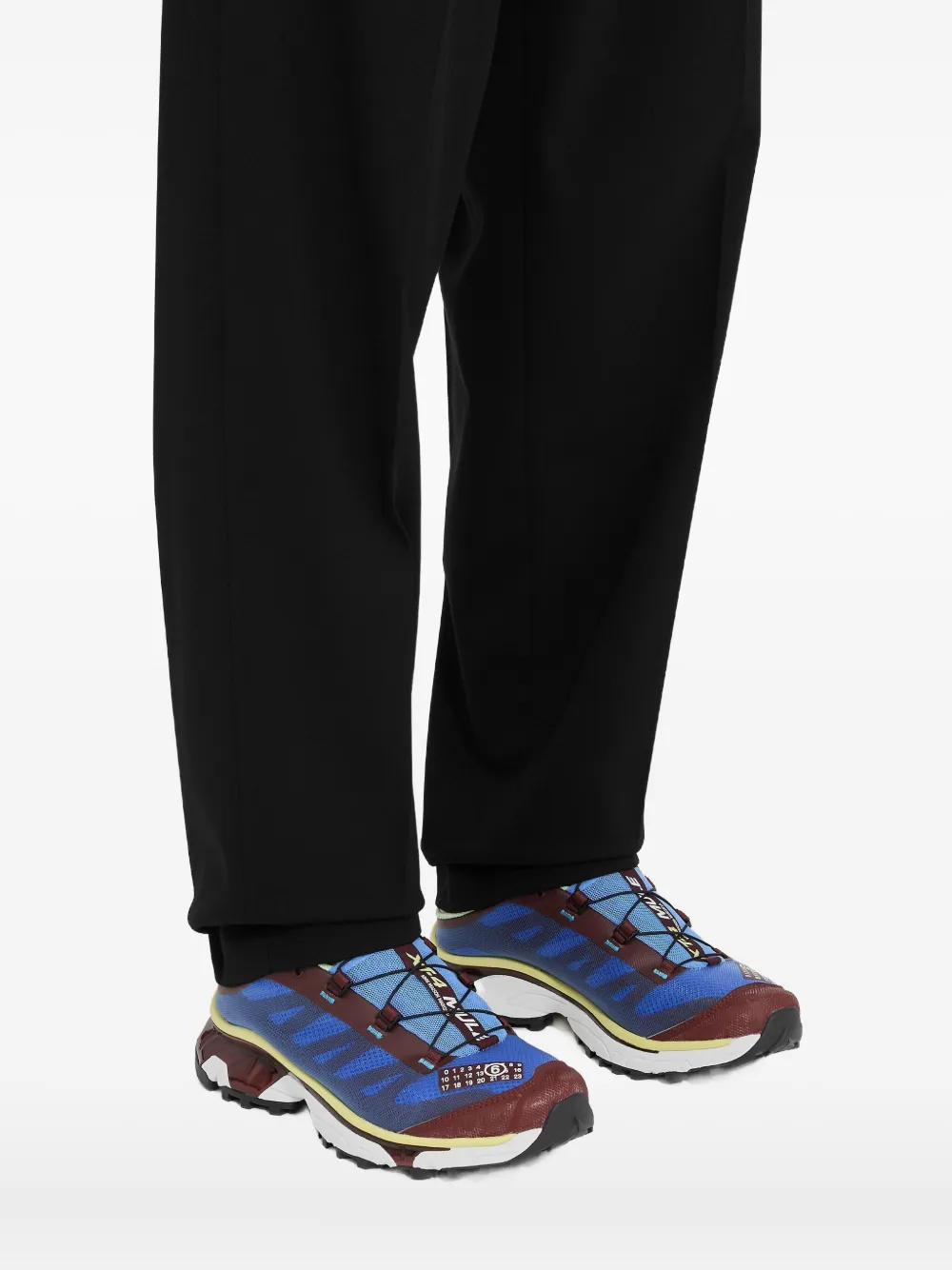 Blue sneakers worn by a person, showing the sneakers fit