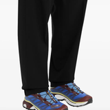 Blue sneakers worn by a person, showing the sneakers fit