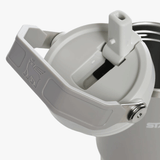 Close up of grey tumbler, showing texture of the steel fabric