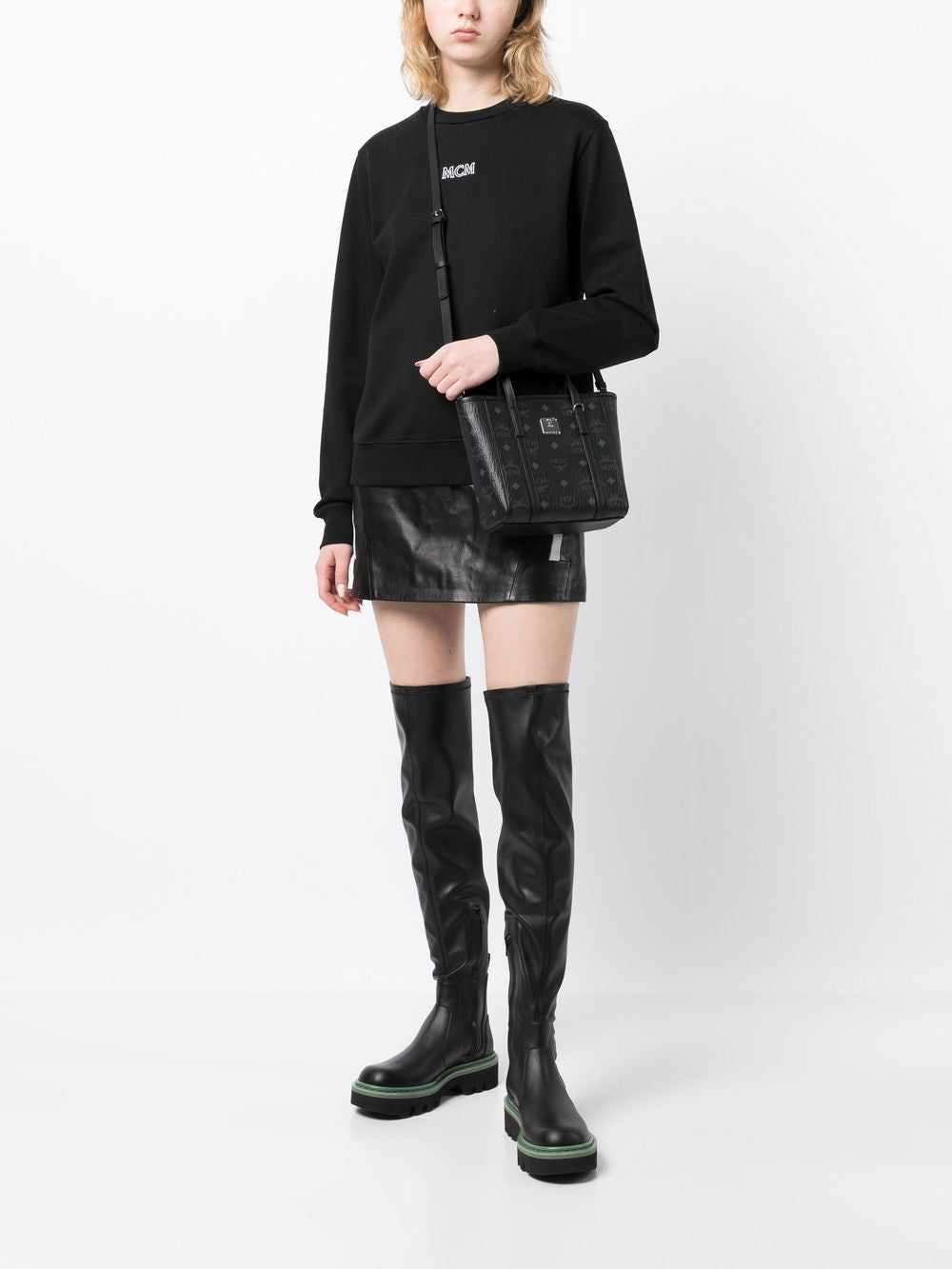 Black bag carried by a person, showing the bag's fit