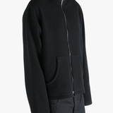 Black jacket worn by a person, showing the jacket's fit