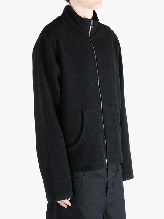 Black jacket worn by a person, showing the jacket's fit