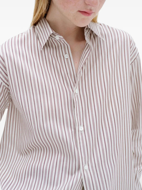 Burgundy shirt worn by a person, showing the shirt fit