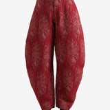 Red pants worn by a person, showing the pants's fit