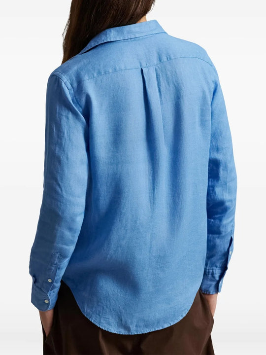 Blue shirt worn by a person, showing the shirt's fit