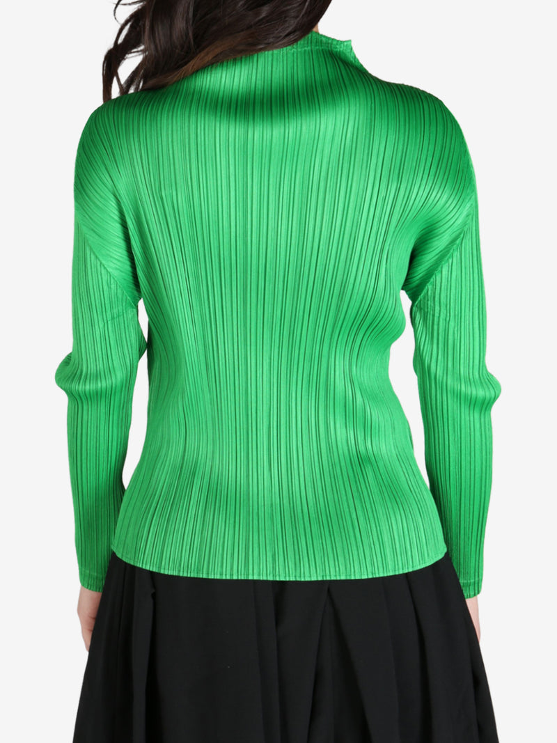 Green top worn by a person, back view