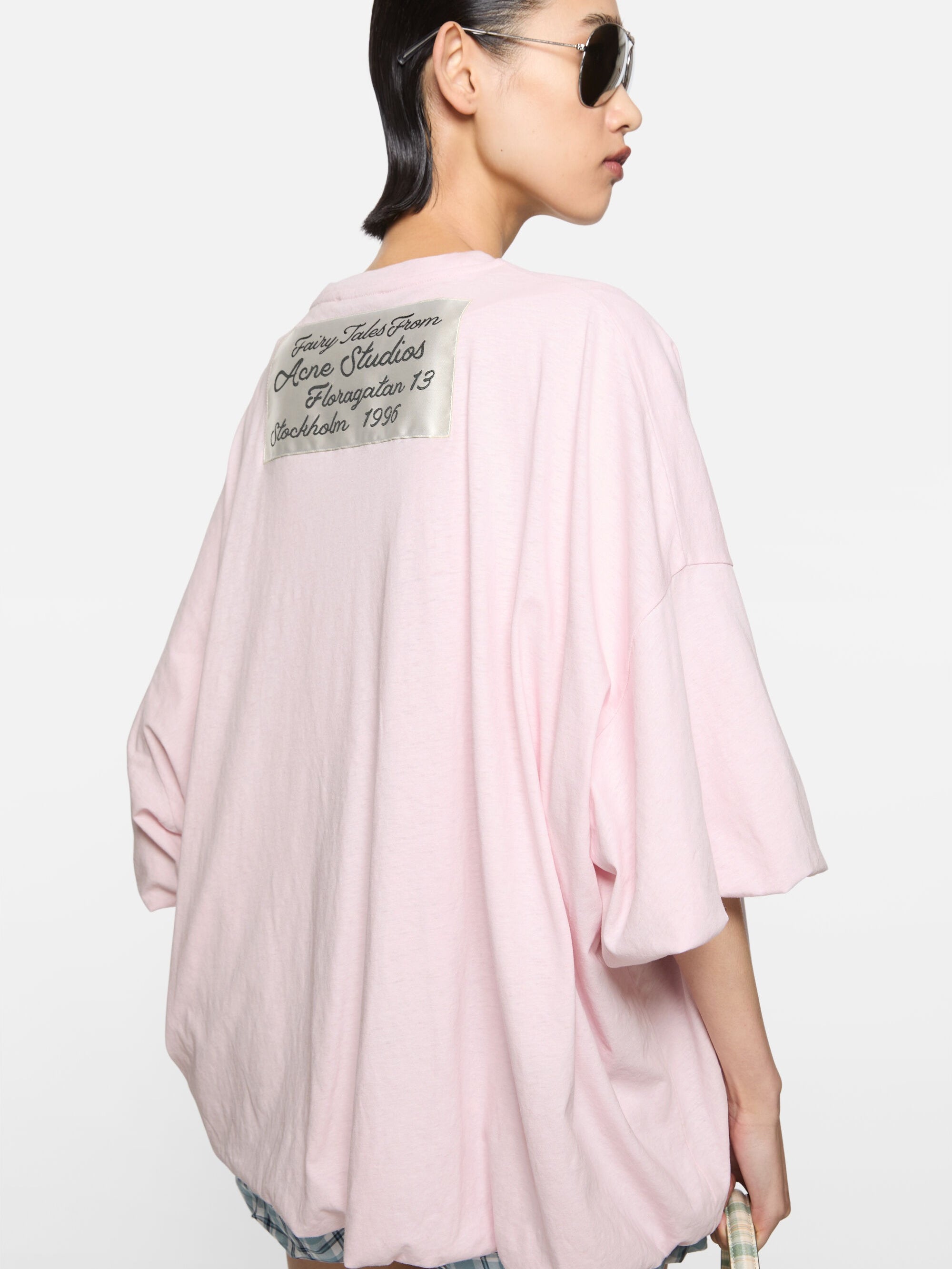 Pink t-shirt worn by a person, showing the t-shirt fit