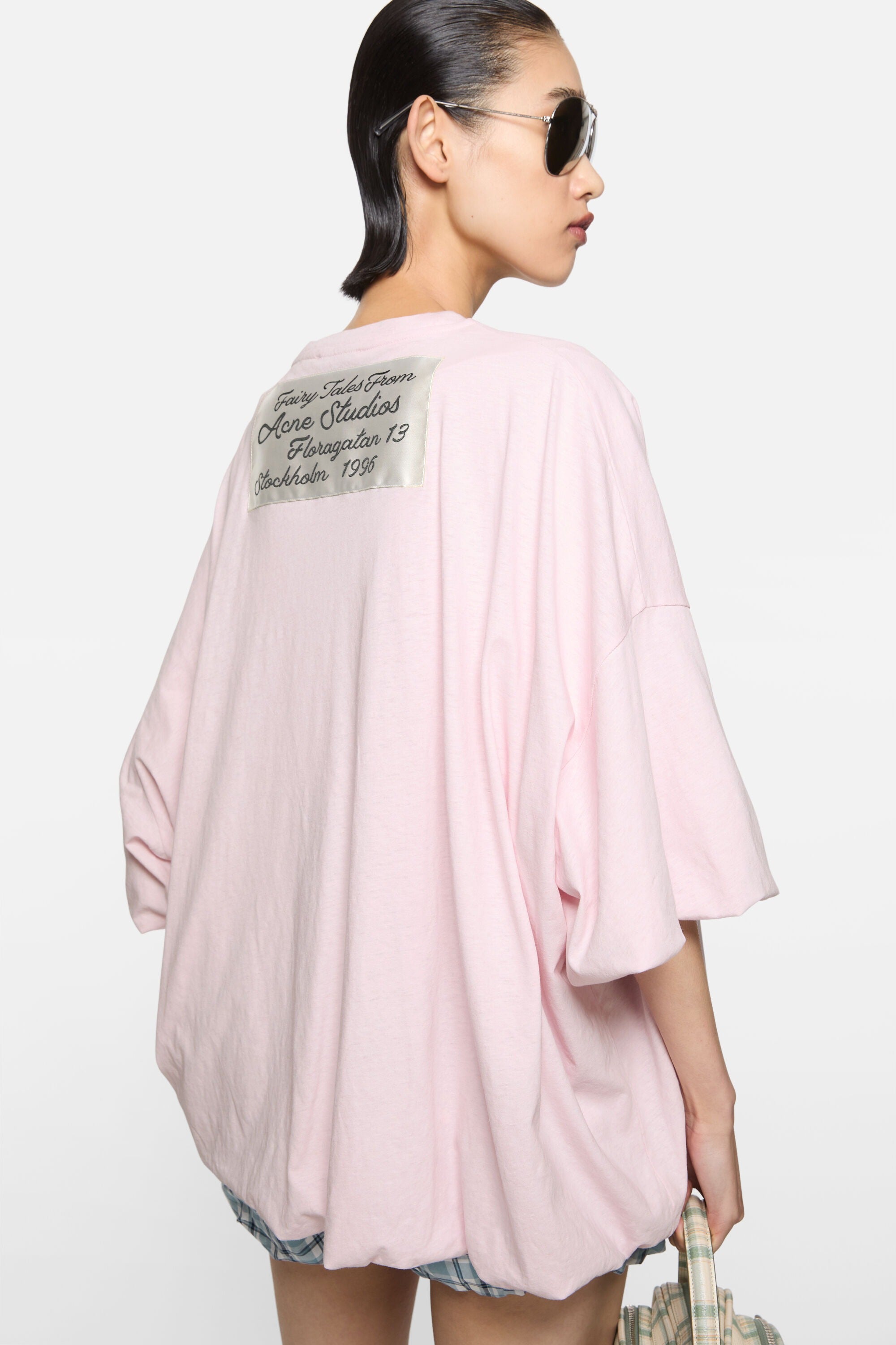 Pink t-shirt worn by a person, showing the t-shirt fit