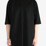 Black shirt worn by a person, showing the shirt's fit