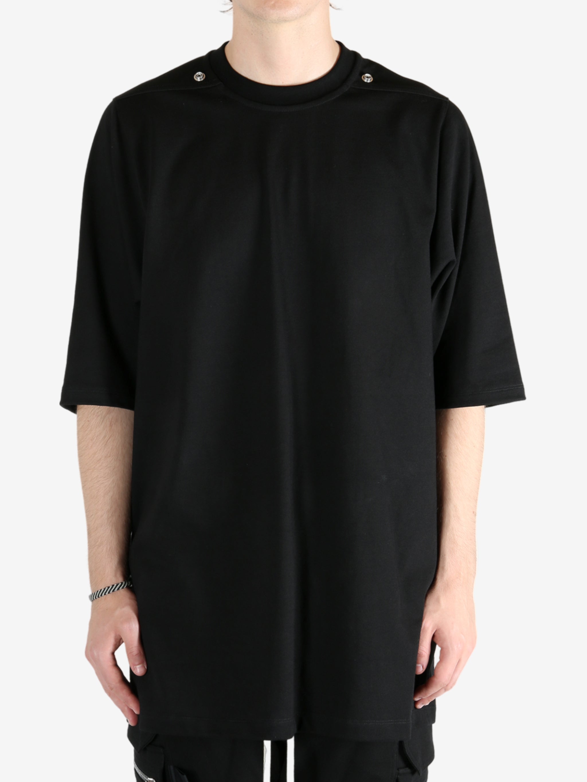 Black shirt worn by a person, showing the shirt's fit