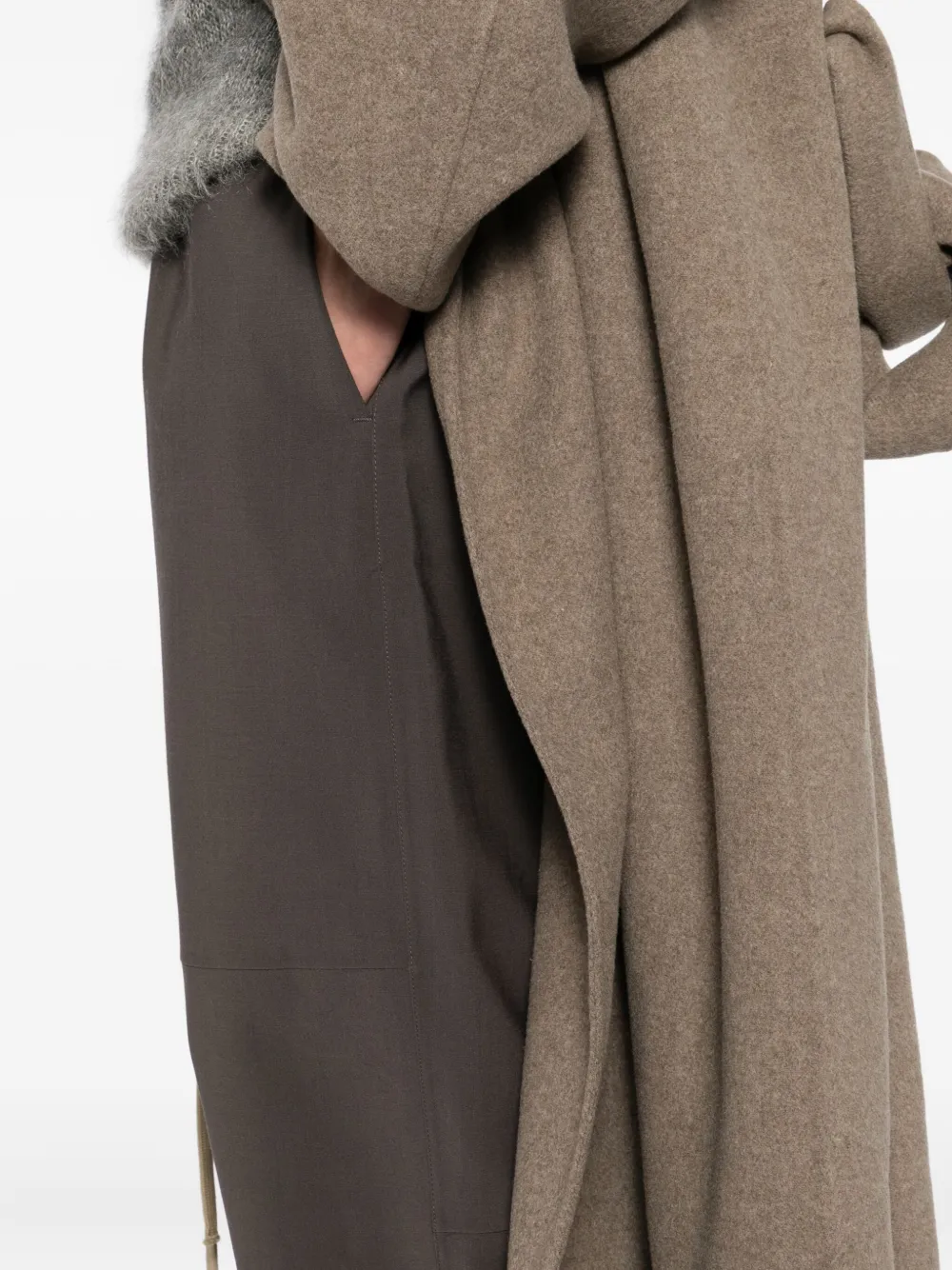 Close up of brown pants, showing texture of the polyester and wool fabric