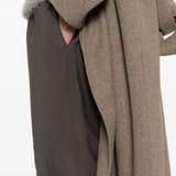 Close up of brown pants, showing texture of the polyester and wool fabric