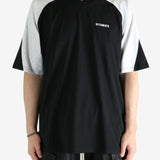 Black t-shirt worn by a person, showing the shirt's fit