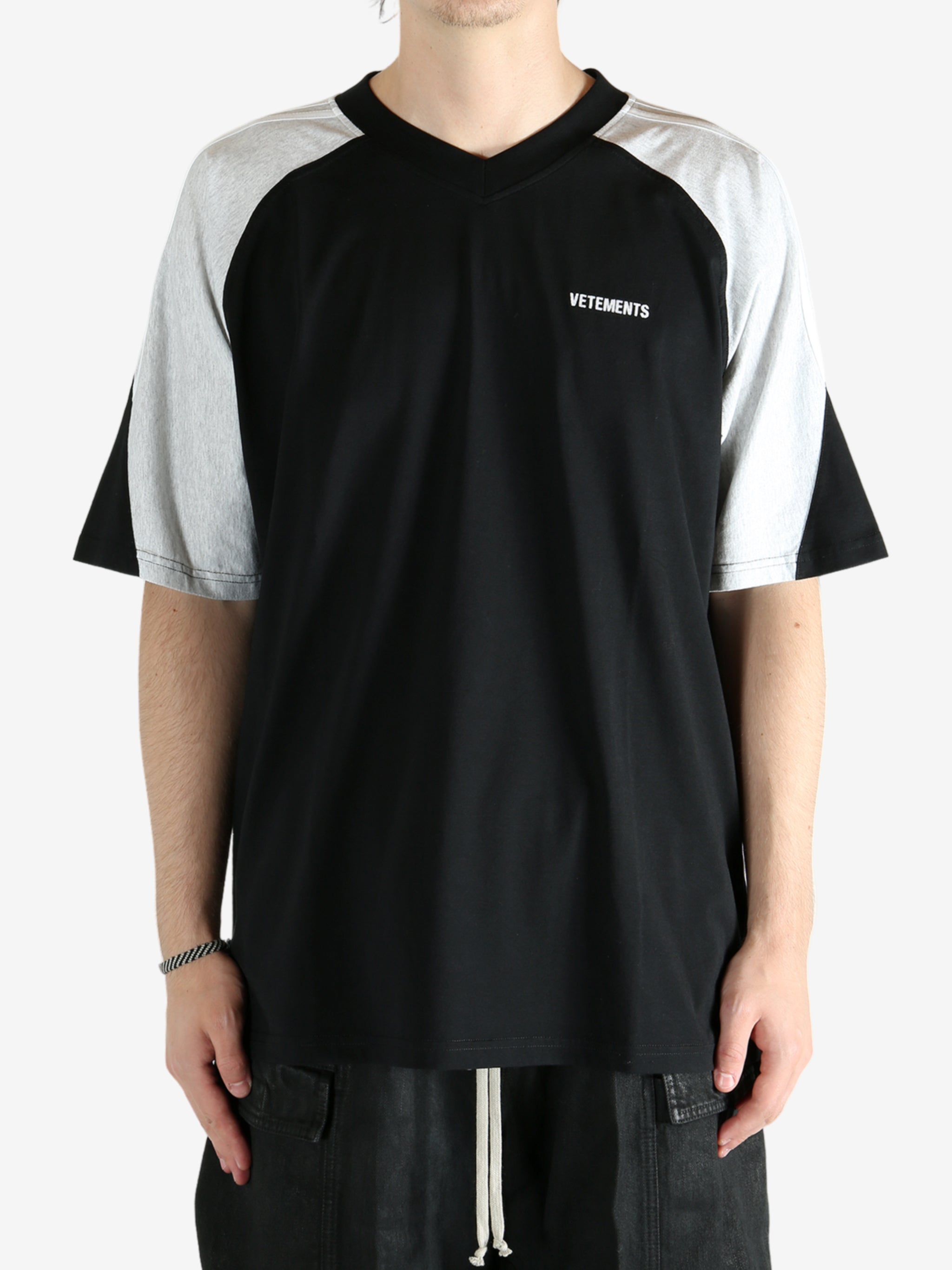 Black t-shirt worn by a person, showing the shirt's fit