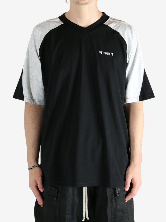 Black t-shirt worn by a person, showing the shirt's fit