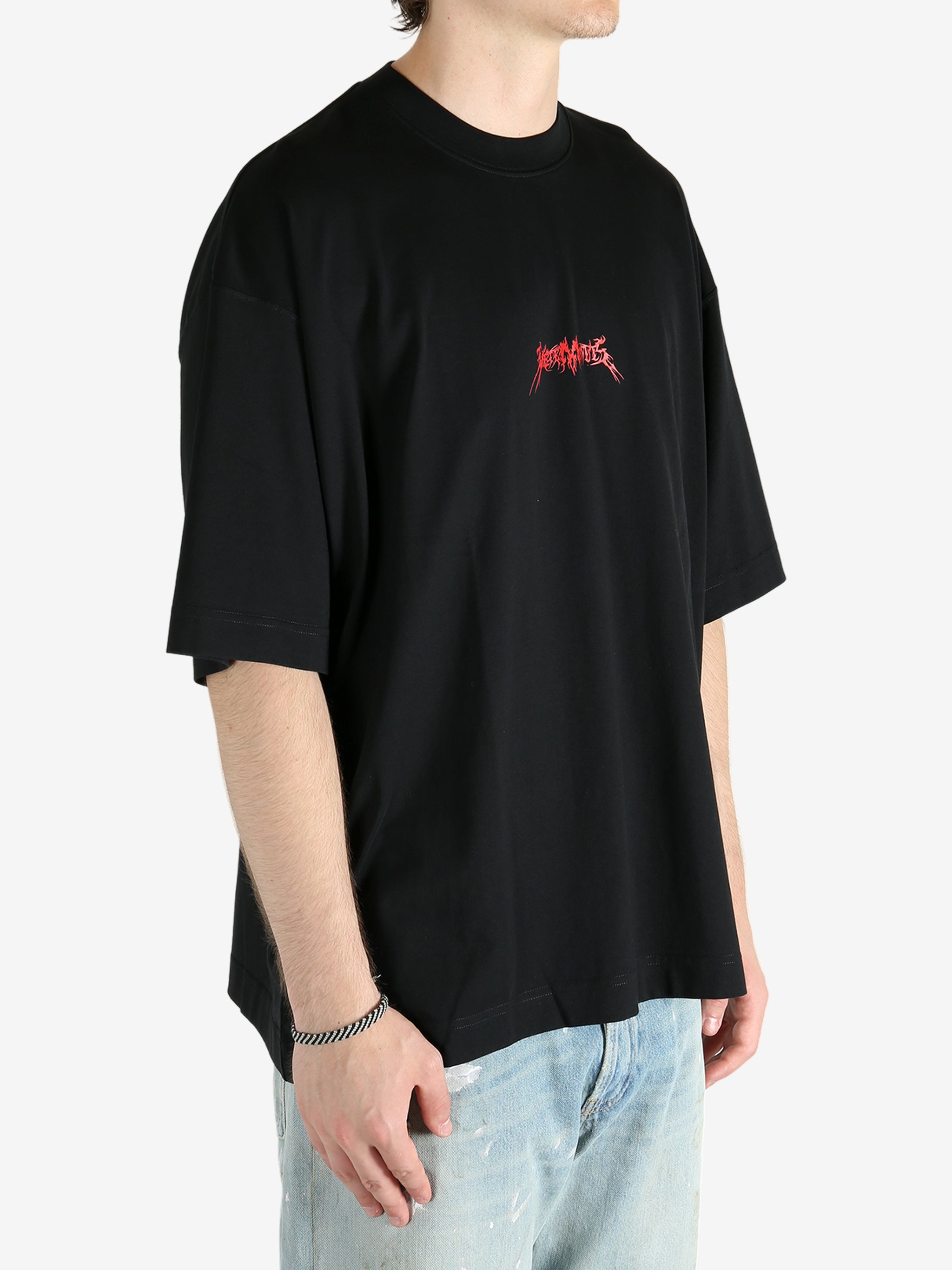 Black t-shirt worn by a person, showing the shirt's fit