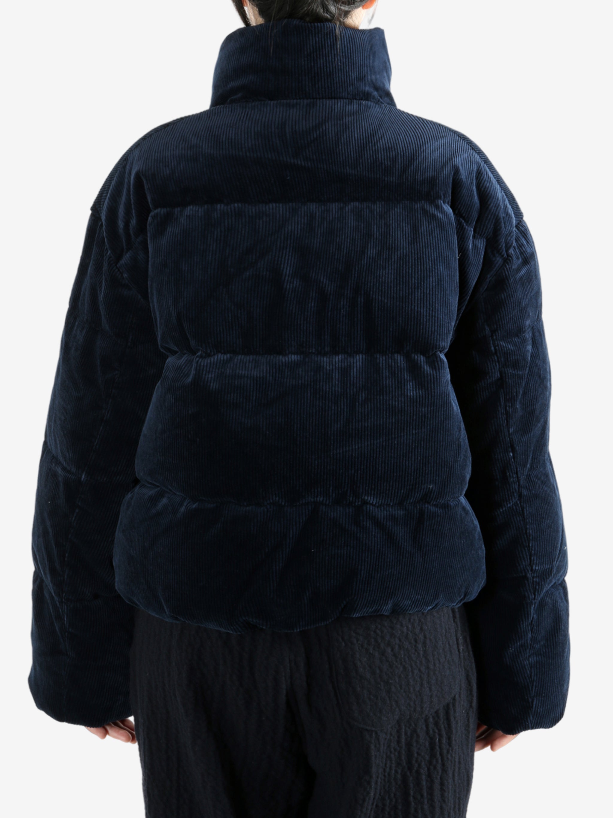 Navy coats worn by a person, showing the coats fit