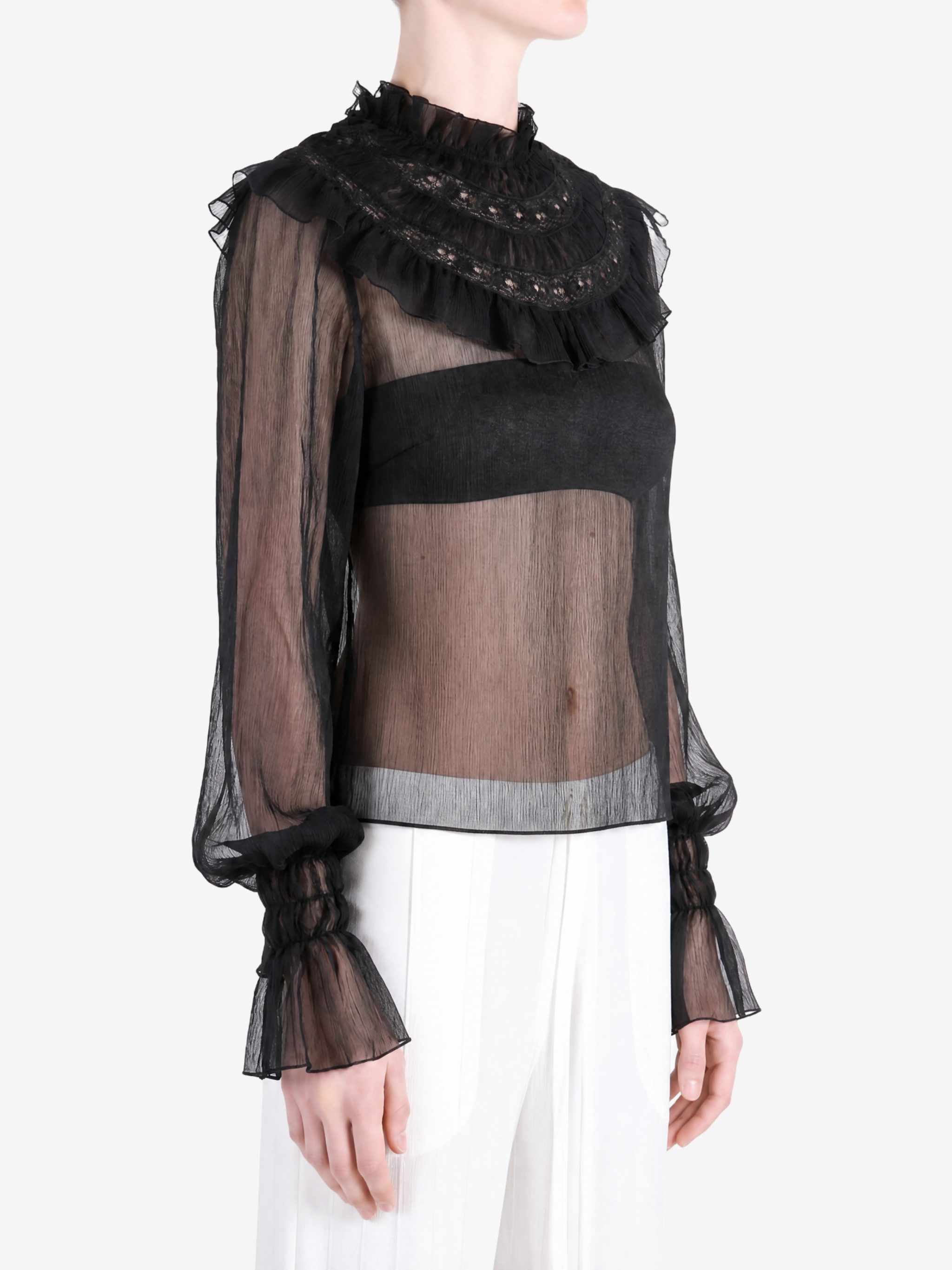 Black top worn by a person, showing the top fit