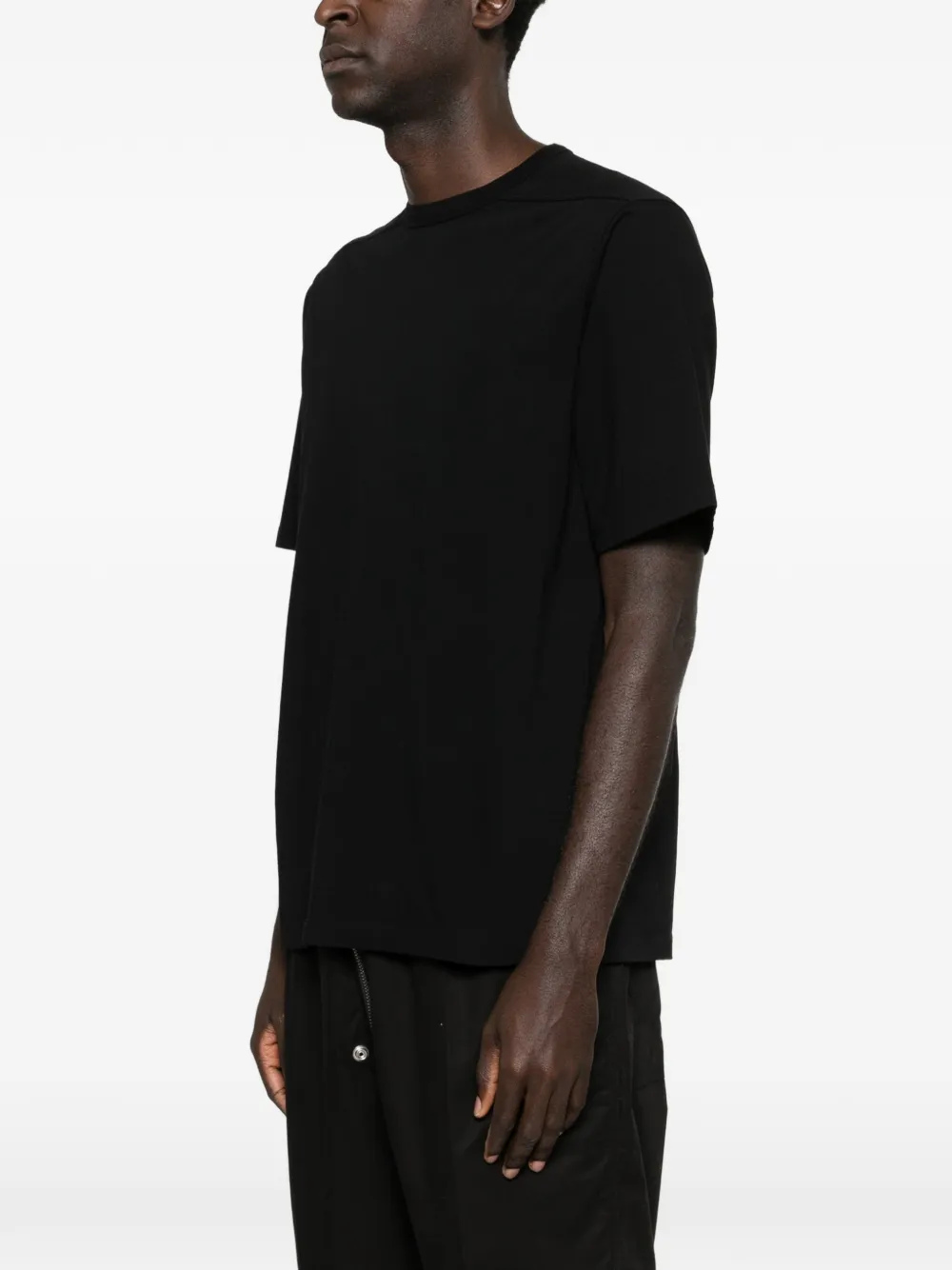 Black shirt worn by a person, showing the shirt's fit