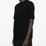 Black shirt worn by a person, showing the shirt's fit