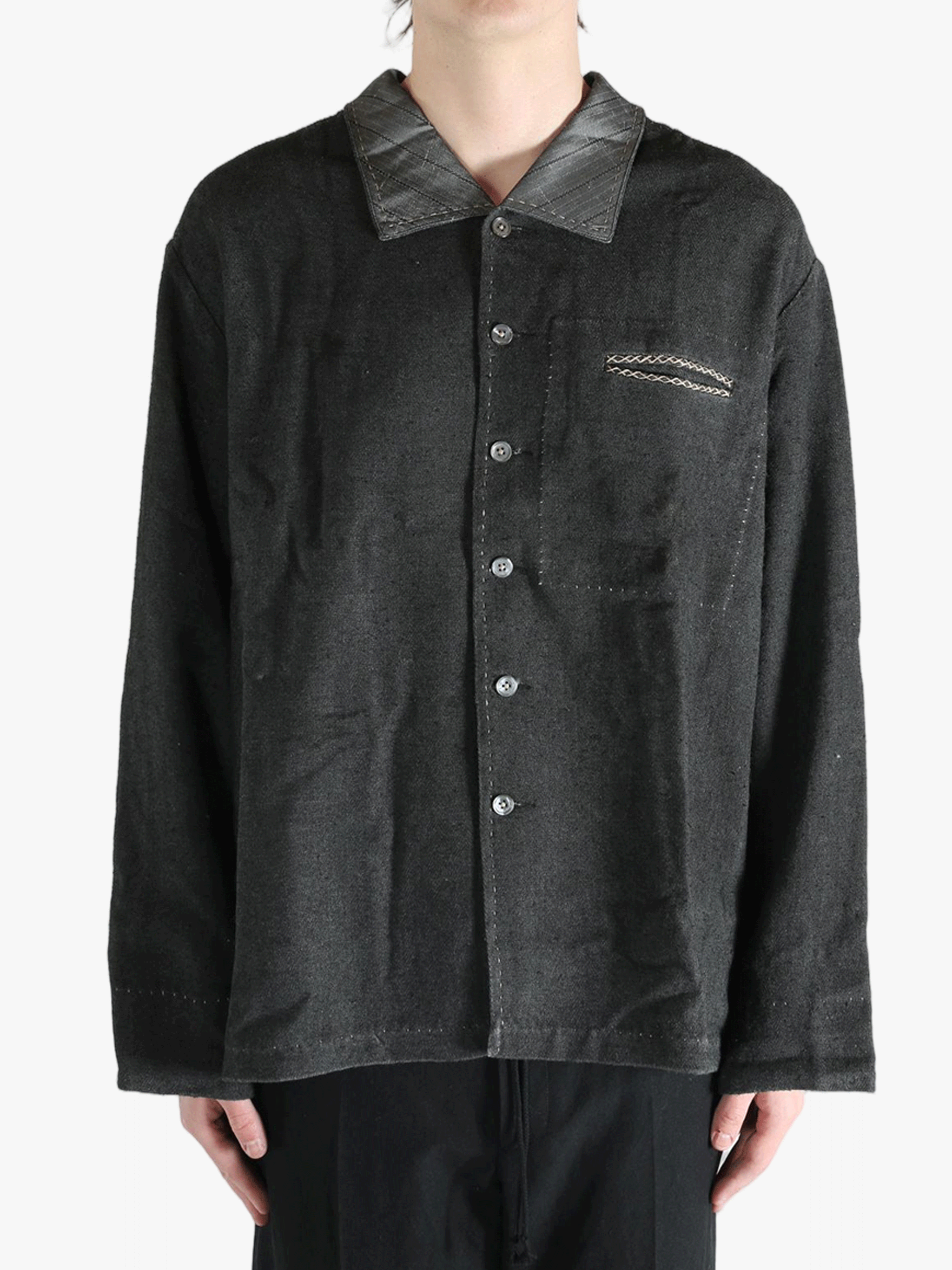 Grey shirts worn by a person, showing the shirts fit