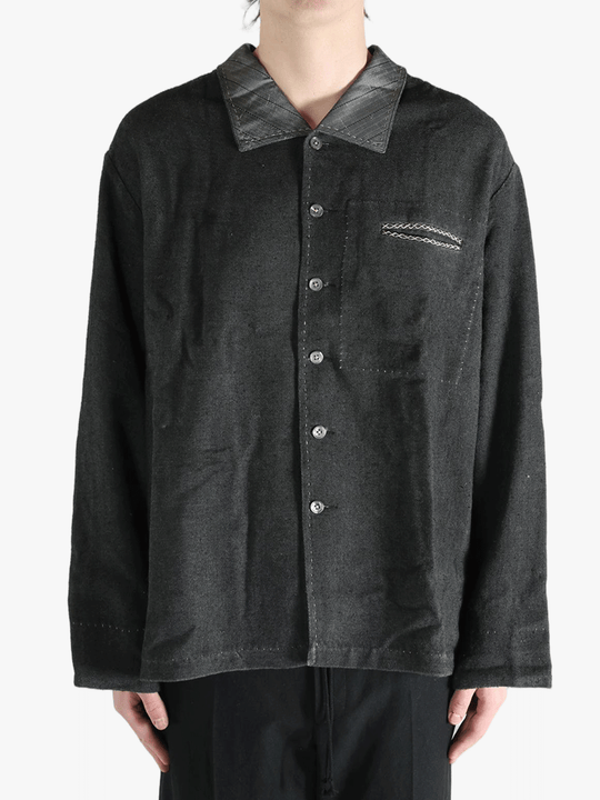 Grey shirts worn by a person, showing the shirts fit