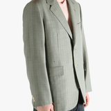Green jacket worn by a person, showing the jacket's fit