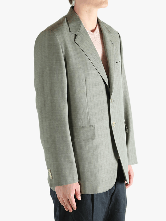 Green jacket worn by a person, showing the jacket's fit