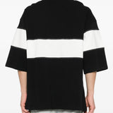 Black T-shirt worn by a person, showing the t-shirt's fit