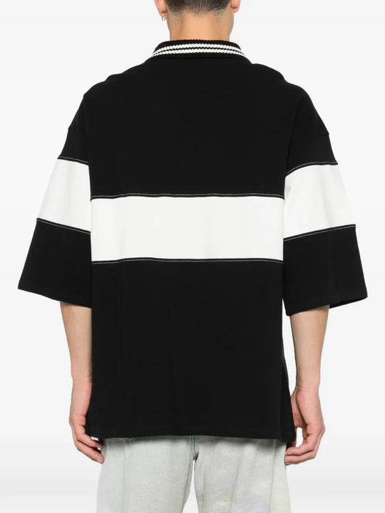 Black T-shirt worn by a person, showing the t-shirt's fit