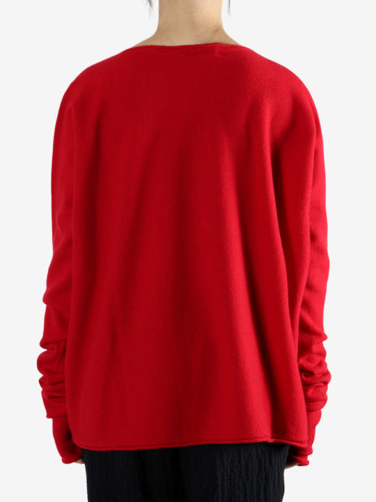 Red knitwear worn by a person, showing the knitwear's fit
