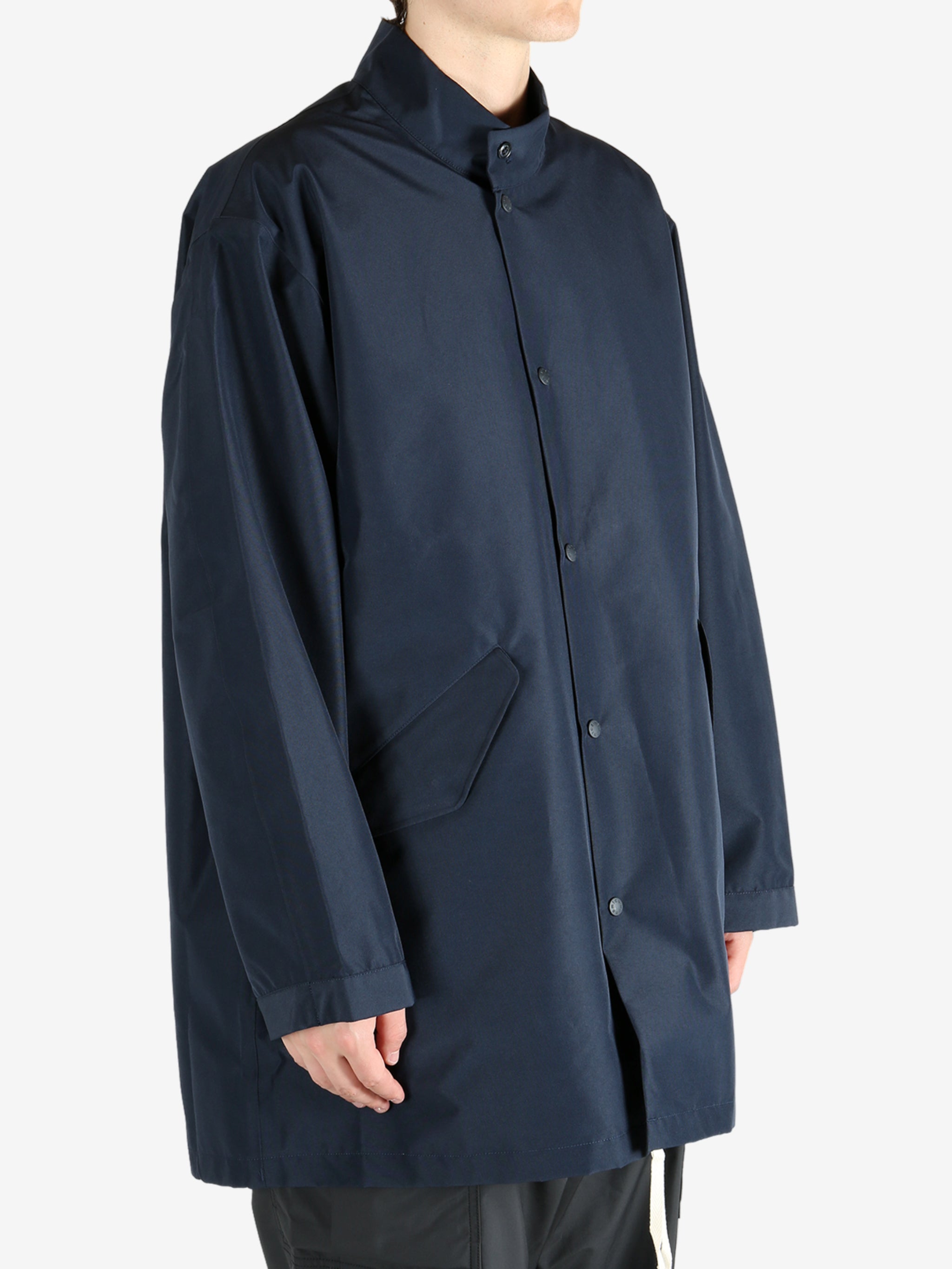 Navy jackets worn by a person, showing the jacket’s fit