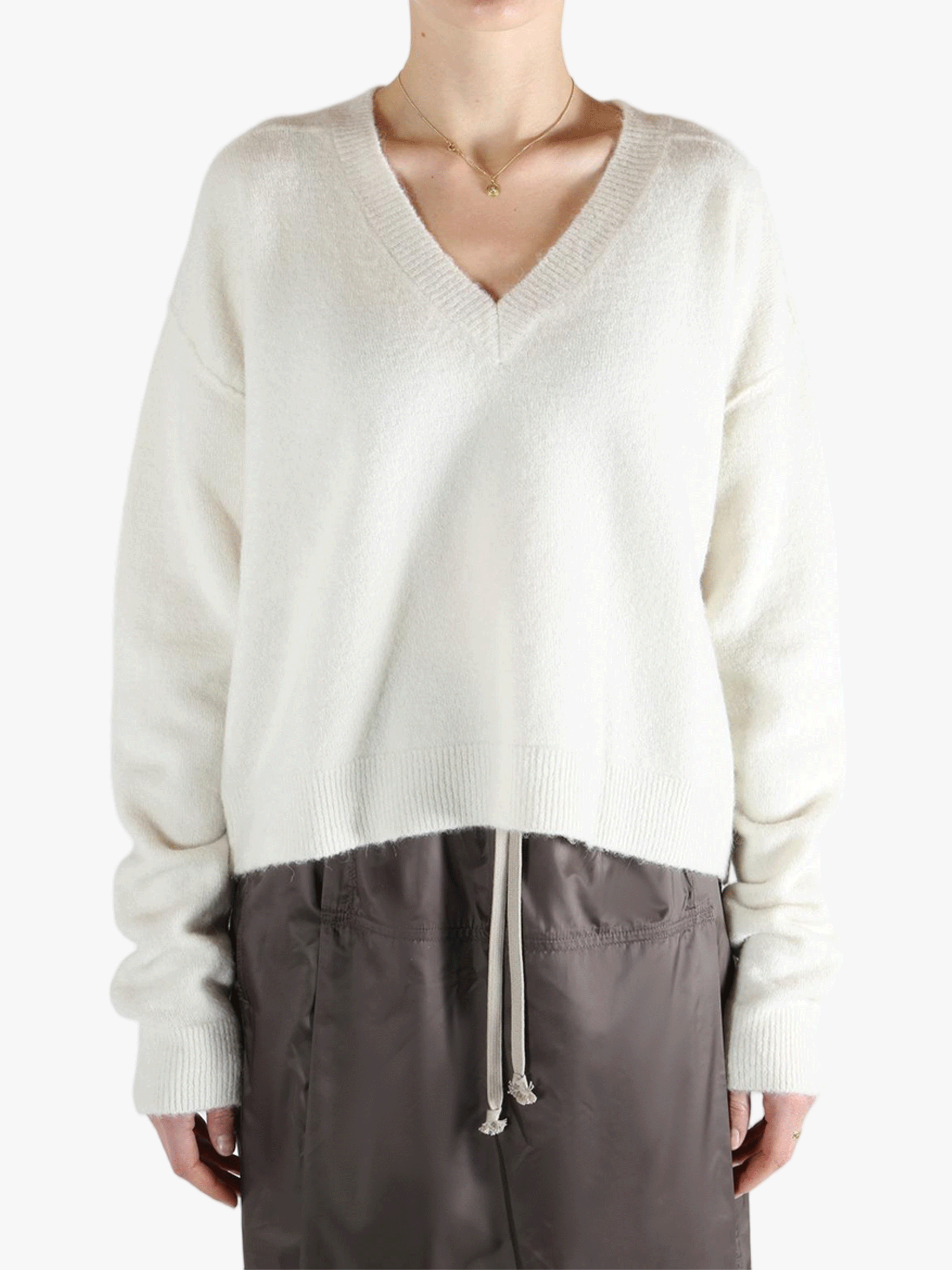 White sweater worn by a person, showing the sweater fit