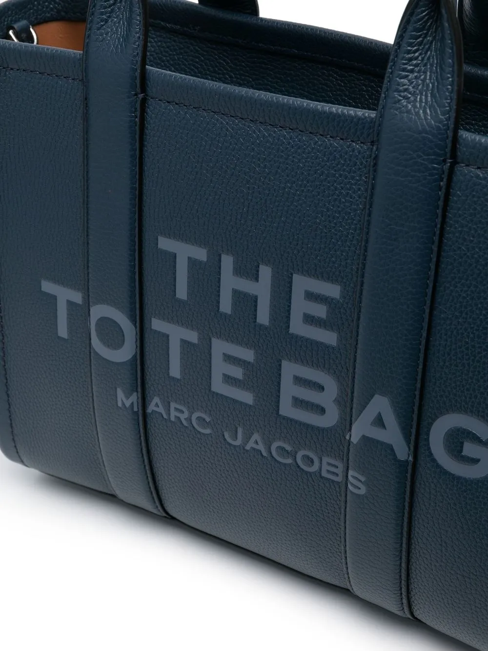 Close up of navy bags, showing texture of the leather fabric