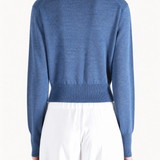 Blue knitwear worn by a person, showing the knitwear fit