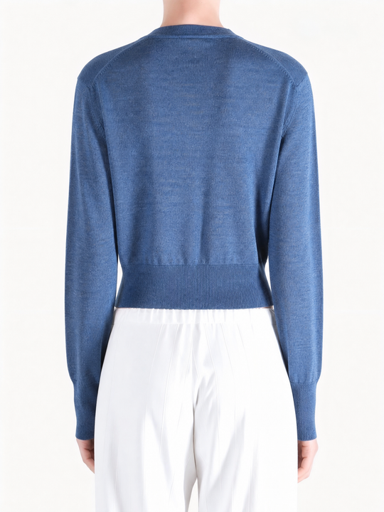 Blue knitwear worn by a person, showing the knitwear fit
