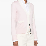 Pink knitwear worn by a person, showing the knitwear's fit