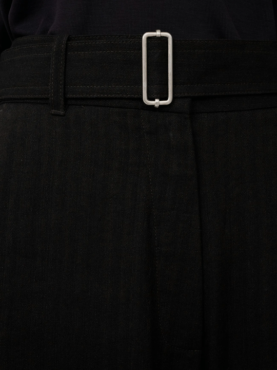Close up of brown pants, showing texture of the cotton fabric