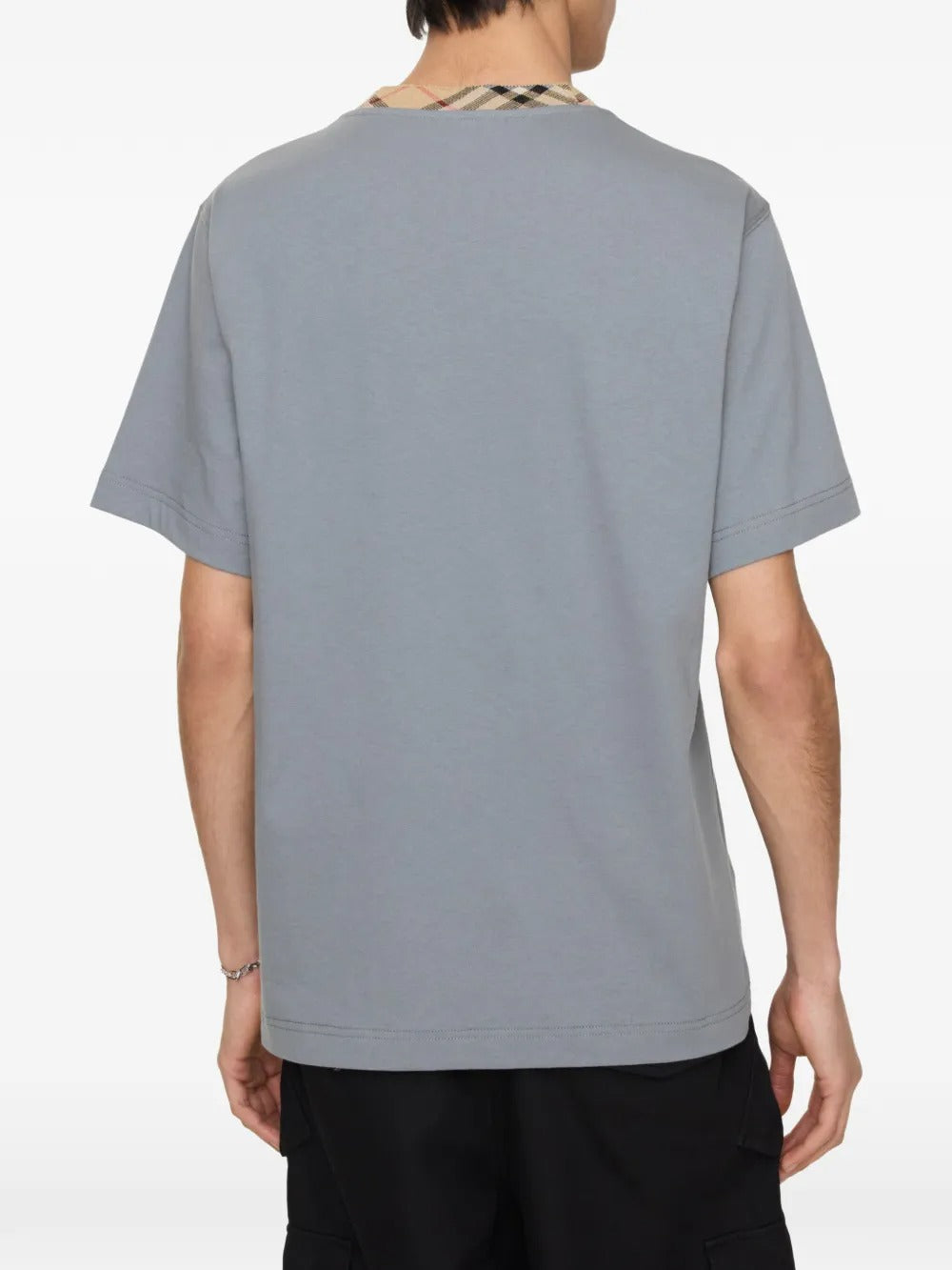 Grey shirt worn by a person, showing the shirt's fit