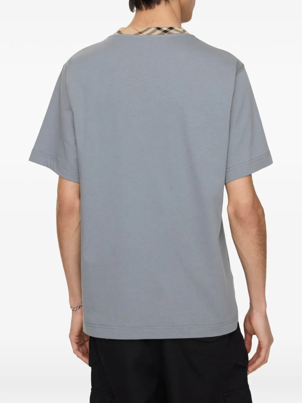 Grey shirt worn by a person, showing the shirt's fit