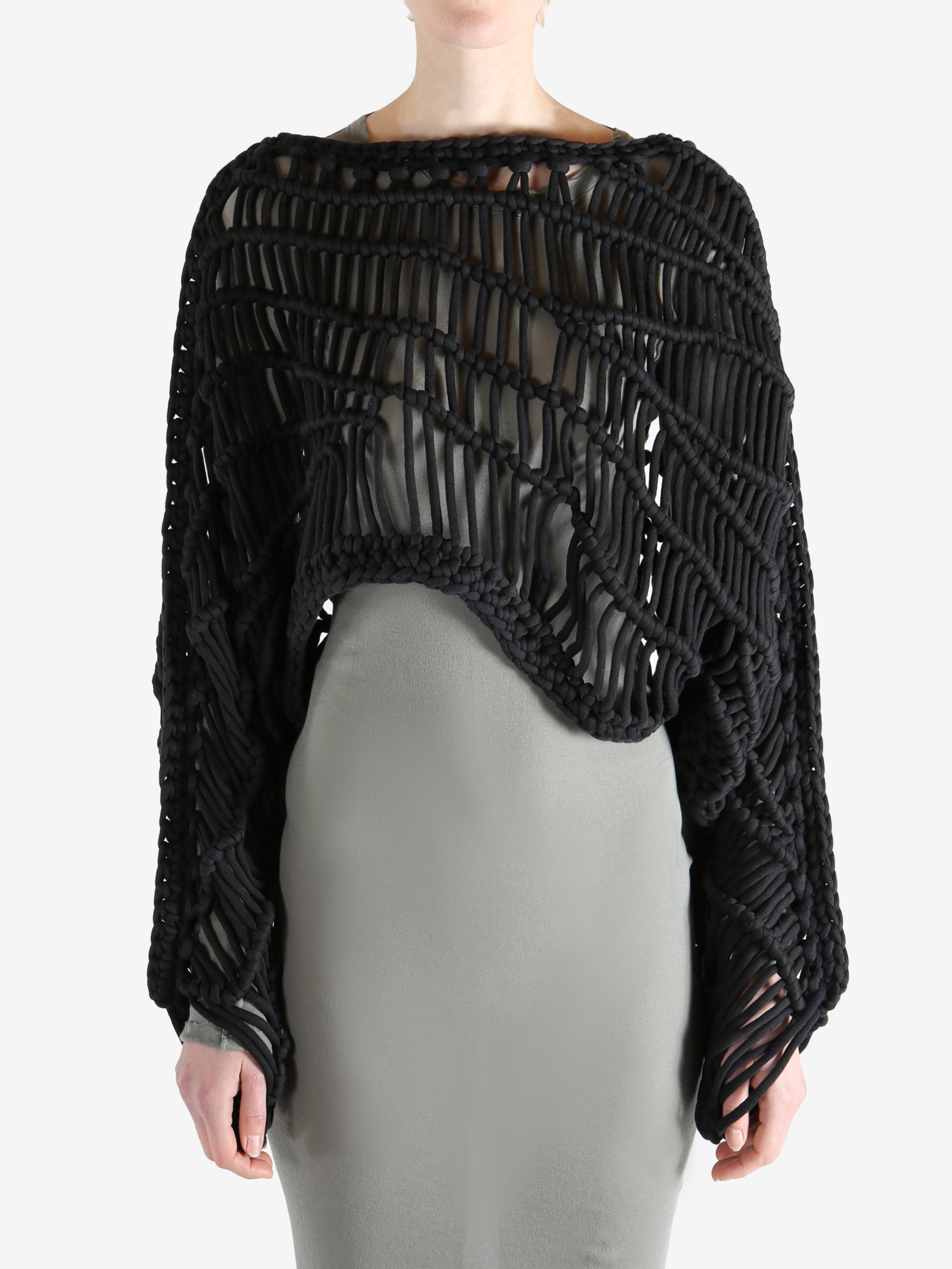 Black knitwear worn by a person, showing the knitwear fit