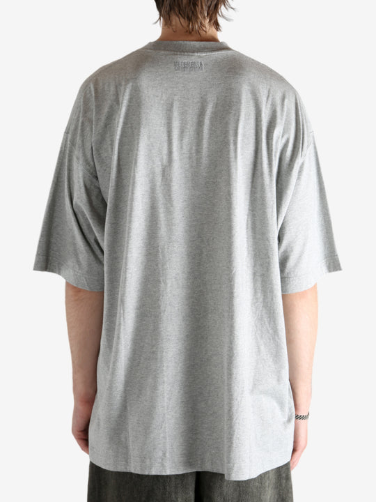 Grey t-shirt worn by a person, showing the shirt's fit