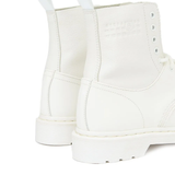 Close up of the white boots, showing texture of the rubber and leather fabric