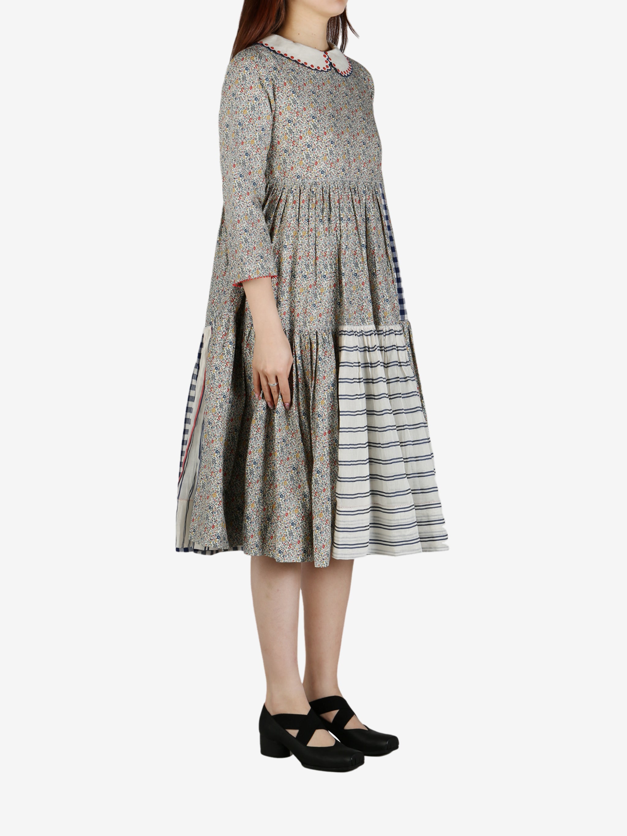 Grey dress worn by a person, showing the dress' fit