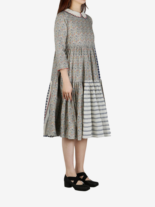 Grey dress worn by a person, showing the dress' fit