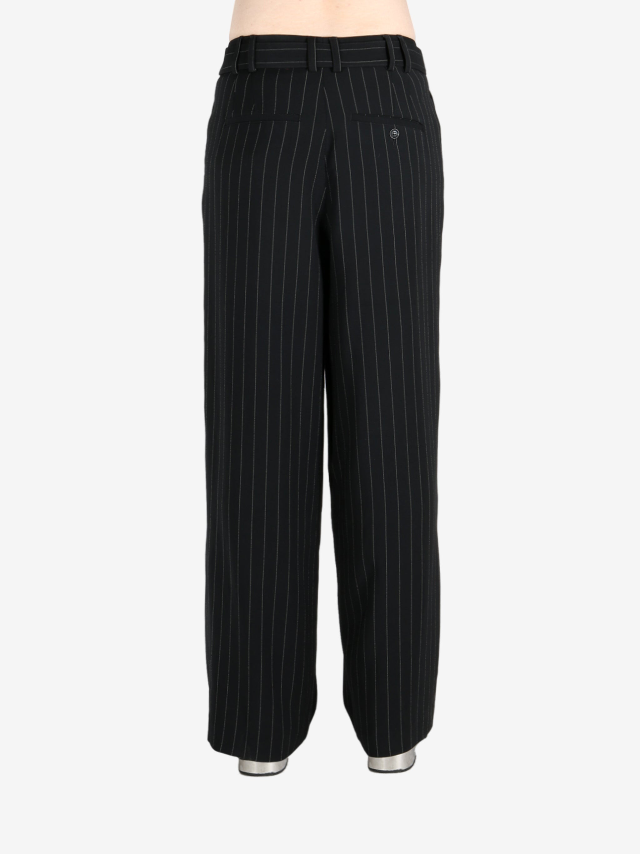 Black pants worn by a person, showing the pants fit