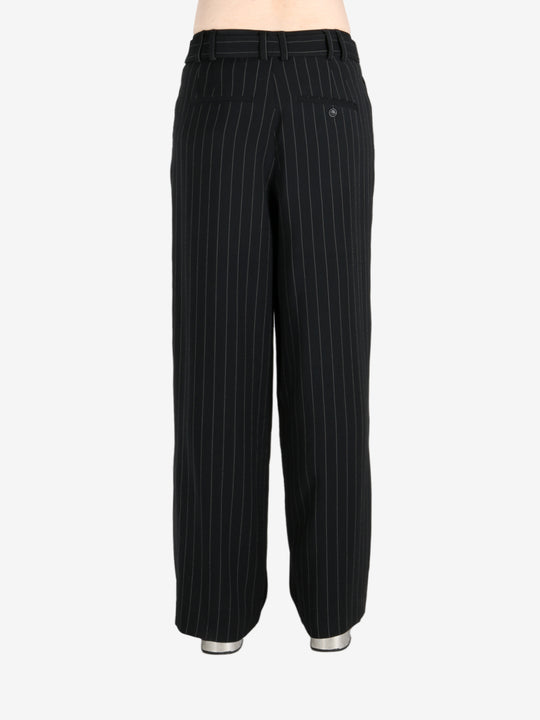 Black pants worn by a person, showing the pants fit