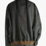 Grey jacket worn by person, showing the jacket's fit