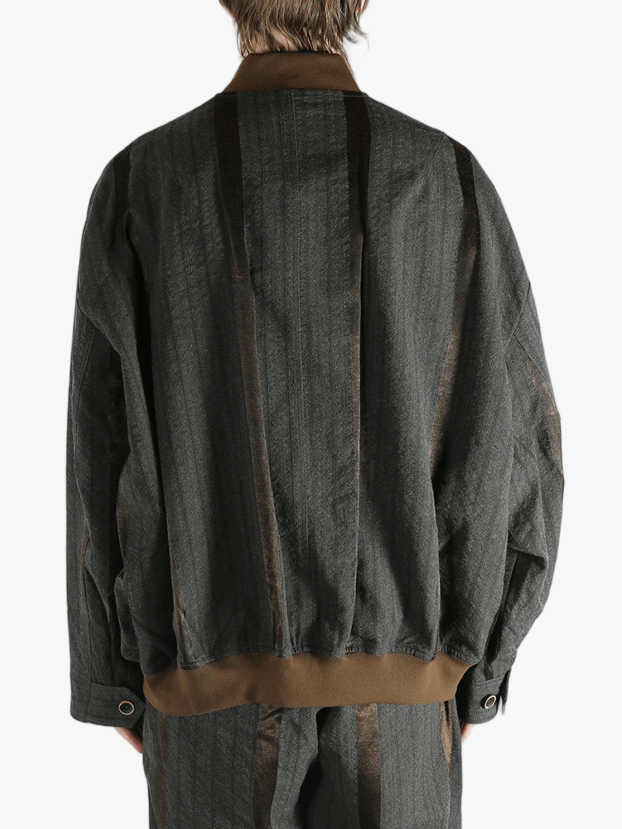 Grey jacket worn by person, showing the jacket's fit