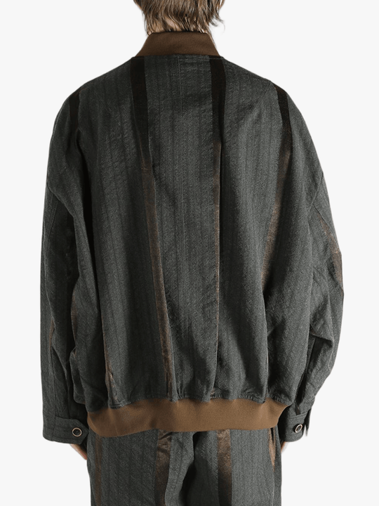 Grey jacket worn by person, showing the jacket's fit